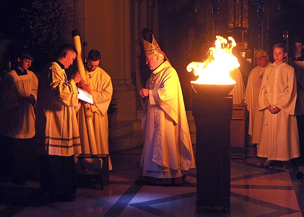 Bishop Richard Malone blesses the new fire at the start of the Easter Vigil at St. Joseph Cathedral. (Dan Cappellazzo/Staff Photographer)